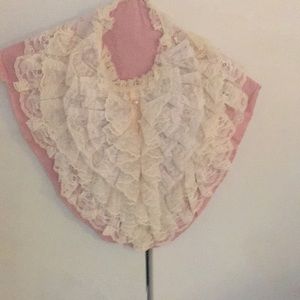 Exquisite lace bib with five rows of lace and pearl buttons from top to bottom.